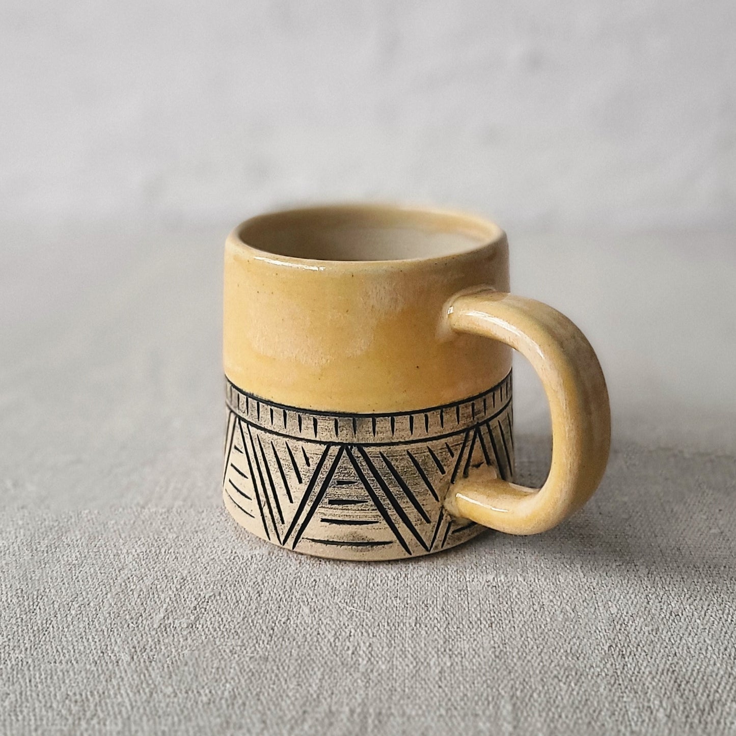 Carved yellow mug